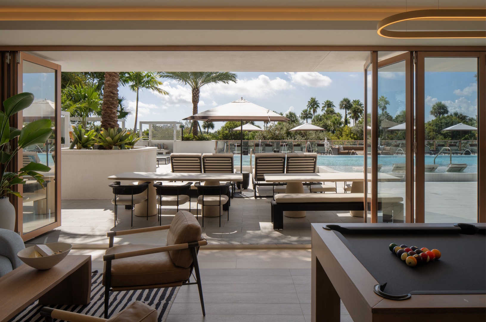 Avara game room with billiards and direct access to the elevated pool deck