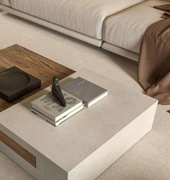Low stone coffee table with books & a small black sculpture